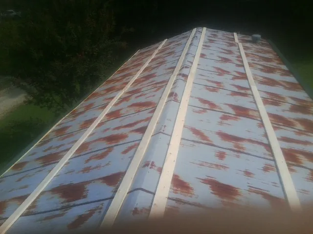 Rusted metal roof panels with new wood purlins before replacement — Storm Damage Roof Repair in Kimmell by Roofing Brothers