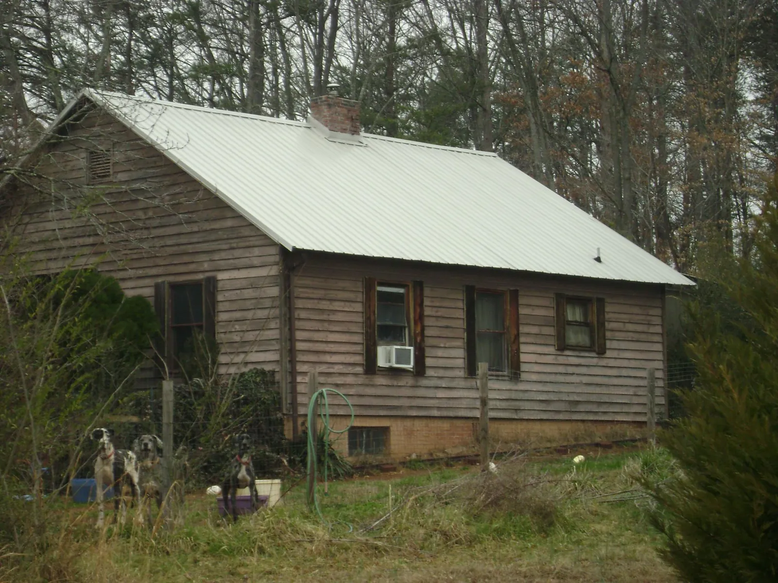 White metal roof on an old wood sided farmhouse, from a Metal Roof Installation job in Kimmell